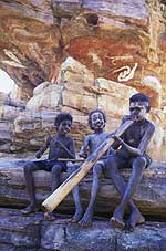 Aboriginal boys playing the didgeridoo and clap sticks at Dukaladjarranji, Northern Territory.