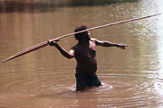 Photograph of George Manyita about to throw a 3-pronged fish spear