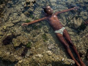 Picture of Aboriginal girl floating in a tide pool