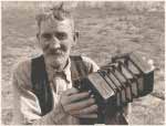 Portrait of Fred Holland playing a concertina, 1957.