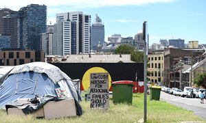 The Redfern Aboriginal tent embassy is seen below the city skyline in Sydney, 2015.