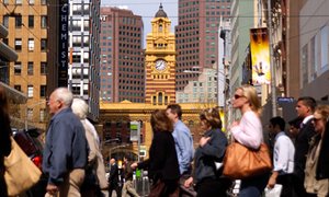 Workers cross the street in Melbourne